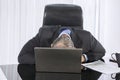 Tired caucasian businessman sleeping in office Royalty Free Stock Photo