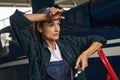 Beautiful woman airframe mechanic wearing overall standing in aviation garage Royalty Free Stock Photo