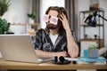 Tired caucasian male student sleeping with stickers on eyes, sitting at table Royalty Free Stock Photo