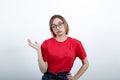 Tired caucasian woman in red shirt having nice glasses. keeping hand on belt