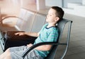 Tired child boy sleeping at the airport Royalty Free Stock Photo