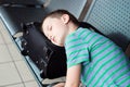 Tired child boy sleeping at the airport Royalty Free Stock Photo