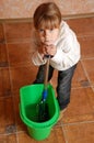 Tired child cleaning up Royalty Free Stock Photo
