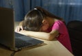 Tired child in front of the computer. Online education for kids. Tired and bored teenage girl sleeping