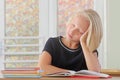 Tired child schoolgirl sleeps during a lesson at the desk in a classroom Royalty Free Stock Photo