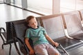 Tired child sleeping in waiting room for passengers. Royalty Free Stock Photo