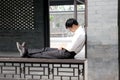 Tired chinese sleeping in a public place