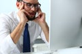 Tired clerk at laptop pc workplace wearing glasses Royalty Free Stock Photo