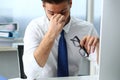 Tired clerk at laptop pc workplace wearing glasses Royalty Free Stock Photo