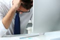 Tired clerk at laptop pc workplace wearing glasses Royalty Free Stock Photo