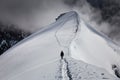 Tired climber going back to refuge on the trail running along the ridge of mountain.ÃÂ  Royalty Free Stock Photo