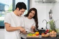 Tired couple cooking and preparing vegetables in kitchen at home, angry woman pointing hand to man Royalty Free Stock Photo