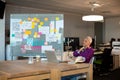 Tired creative businesswoman sitting on desk