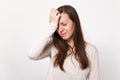 Tired crying disconcerted young woman in light clothes keeping eyes closed, putting hands on head isolated on white Royalty Free Stock Photo