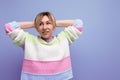 tired cute blondie woman stretching on purple background