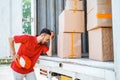 Tired delivery man having headache while working with cardboard boxes Royalty Free Stock Photo