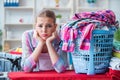 The tired depressed housewife doing laundry Royalty Free Stock Photo