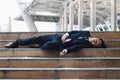 Tired and disappointed young Asian business man lying down and feeling stressed. Unemployment and layoff concept Royalty Free Stock Photo