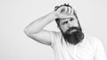 Tired and disappointed young bearded man over white wall. Copy space. Hipster guy feeling fatigue and headache. Stress and Royalty Free Stock Photo
