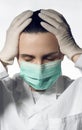 Portrait of Tired Doctor in surgical mask and gloves with closed eyes Royalty Free Stock Photo