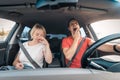 Tired and drowsy driver man yawns while next to sleeping exhausted wife. Driving car at high speed on road. Risk and hazard of