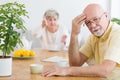 Tired elderly man arguing with his wife in the morning