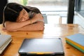 Tired exhausted girl student sleeping after studying hard exam in library Royalty Free Stock Photo