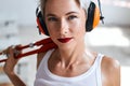 Tired exhausted blonde girl with beautiful makeup in white top Royalty Free Stock Photo