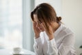 Tired exhausted businesswoman feeling strong headache at work to Royalty Free Stock Photo