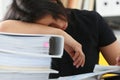 Tired and exhausted woman have a lot of work with documents fall asleep