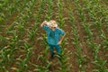 Tired exhausted farmer standing in cultivated sorghum field