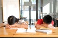 Tired exhausted girl boy student sleeping after studying hard exam in library Royalty Free Stock Photo