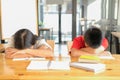 Tired exhausted girl boy student sleeping after studying hard exam in library Royalty Free Stock Photo