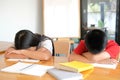 Tired exhausted girl boy student sleeping after studying hard exam in library Royalty Free Stock Photo