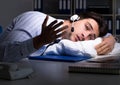 Tired and exhausted helpdesk operator during night shift Royalty Free Stock Photo