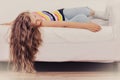 Tired exhausted lazy little girl kid lying on sofa Royalty Free Stock Photo