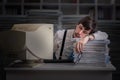 Tired exhausted man is sleeping at workplace at night. Overwork concept. Royalty Free Stock Photo