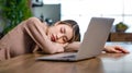Tired exhausted sleepy Asian young female businesswoman freelancer sitting napping sleeping on table resting relaxing from home Royalty Free Stock Photo