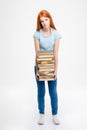 Tired exhausted woman standing and holding stack of books Royalty Free Stock Photo