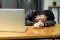 Tired or exhausted young business woman napping on working desk Royalty Free Stock Photo