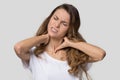 Tired exhausted young woman massaging tensed neck muscles Royalty Free Stock Photo