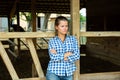 Tired farm worker stands near the corral