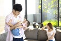 Tired father and mother with their baby at home Royalty Free Stock Photo