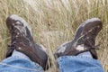 Tired feet in dirty hiking shoes after a hike in sand dunes