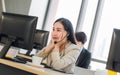 Tired female customer service agent with colleagues in background at call center Royalty Free Stock Photo