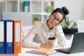 Tired female employee sleeping at work, exhausted woman resting at desk near laptop and folders Royalty Free Stock Photo