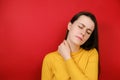 Tired female feeling stiff sore neck pain concept rubbing massaging tensed muscles suffer from fibromyalgia, has gloomy expression Royalty Free Stock Photo