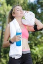 Tired female jogger using towel