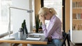 Tired female office employee feeling stress while working