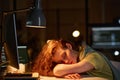 Tired female programmer sleeping at her workplace Royalty Free Stock Photo